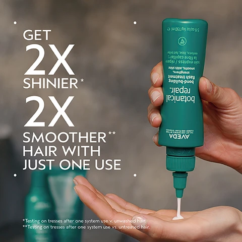 Image 2 - A hand holds a green Aveda Botanical Repair bond-building flash treatment bottle, squeezing white product into the palm of the other hand, with prominent text stating GET 2X SHINIER* 2X SMOOTHER** HAIR WITH JUST ONE USE, and the bottle label includes 5 fl oz/oz liq/150 ml e, soin express / répare la fibre capillaire, renforce, lisse, fait briller, strengthens, smooths, adds shine, flash treatment, bond-building, botanical repair, AVEDA, THE ART AND SCIENCE OF PURE FLOWER AND PLANT ESSENCES, while fine print at the bottom reads *Testing on tresses after one system use v. unwashed hair. **Testing on tresses after one system use vs. untreated hair. Image 3 - A split image shows a persons blonde hair from the side, with the left side depicting dull, unwashed hair and the right side showing smooth, styled hair, labeled BEFORE, AFTER, Unwashed Hair, and Results with botanical repair™ strengthening shampoo, conditioner, and bond-building flash treatment. Blow dried with round bristle hair brush and styled with hair styling iron. Image 4 - A dark green graphic with a swirling, translucent green and yellow circle in the center. Text: PLANT-DERIVED BOND BUILDING MOLECULE. PLANT-DERIVED BOND BUILDING MOLECULE PENETRATES DEEP WITHIN THE CORTEX BUILDING NEW BONDS FOR STRONGER HAIR. NOURISHING MACRO-GREEN BLEND. WITH AVOCADO, GREEN TEA AND SACHA INCHI OILS SMOOTHS THE CUTICLE TO DETANGLE AND HELP PREVENT BREAKAGE. Image 5 - The image shows a split screen with BEFORE on the left depicting a person with voluminous, frizzy, unwashed dark hair, and AFTER on the right showing the same person with long, smooth, straight dark hair, accompanied by the text Unwashed Hair and Results with botanical repair™ strengthening shampoo, conditioner, and bond-building flash treatment. Blow dried with round bristle hair brush and styled with hair styling iron. Image 6 - An infographic displays a four-step hair care routine with circular images on a green, leaf-patterned background, showing 1) hands washing dark, curly hair, 2) hands applying a dark masque to wet hair, 3) a hand squeezing cream from a green bottle into a palm, and 4) a hand combing through damp hair, with the accompanying text: HOW TO USE 01 CLEANSE Botanical Repair Strengthening Shampoo 02 CONDITION Botanical Repair Strengthening Masque: Rich 03 REPAIR Botanical Repair Strengthening Leave-In Treatment and Botanical Repair Bond-Building Flash Treatment 04 STYLE Botanical Repair Strengthening Bond-Building Styling Creme. Image 8 - The image displays three white certification logos against a dark green leafy background, indicating 100% VEGAN, Certified B Corporation, and Cruelty Free International.