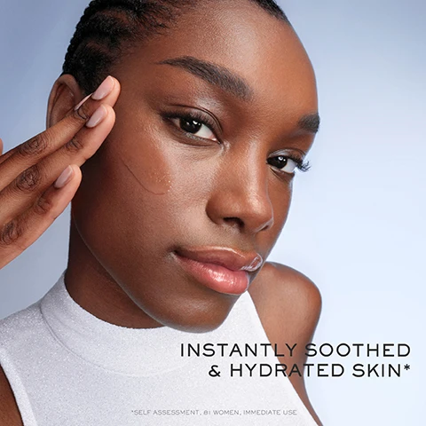 Image 1 - A close-up image of a woman with smooth skin and dark hair, gently touching her cheek with one hand while looking at the camera, with the text INSTANTLY SOOTHED & HYDRATED SKIN visible at the bottom, along with the note *SELF ASSESSMENT, 81 WOMEN, IMMEDIATE USE*.
Image 2 - A woman with slicked-back hair applies a drop of serum to her cheek with a dropper, and visible text on the bottom left states 93% say skin looks smoother, 90% say skin quality looks improved, and 82% say skin looks more glowing & luminous.
Image 3 - A promotional image featuring two bottles of Lancôme skincare products, one labeled Advanced Génifique Strength Radiance and the other labeled New Génifique Ultimate, with text stating Reverses visible skin damage and a note about the appearance of fine lines and wrinkles.
Image 4 - A young woman with smooth skin and a subtle glow touches her cheek, wearing a shiny silver top, with the text suitable for all skin types, including sensitive skin displayed below her.