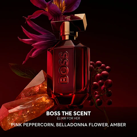 Image 2 - A stylish red glass perfume bottle with a gold cap is surrounded by purple flowers, amber crystals, and pink peppercorns, with visible text reading BOSS THE SCENT ELIXIR FOR HER PINK PEPPERCORN, BELLADONNA FLOWER, AMBER.
Image 3 - A red perfume bottle labeled BOSS is displayed against a dark background, with a quotation about the fragrance from Christina of Home Tester Club and a five-star rating visible.
Image 4 - A display of four perfume bottles from the BOSS brand on a reflective surface, labeled as Eau de Parfum, Magnetic Eau de Parfum, Parfum, and Elixir, along with scent family and intensity level descriptions for each.
Image 5 - An elegant display of two dark red perfume bottles on a round pedestal, featuring the brand name BOSS prominently on each bottle and the text THE SCENT ELIXIR above them.