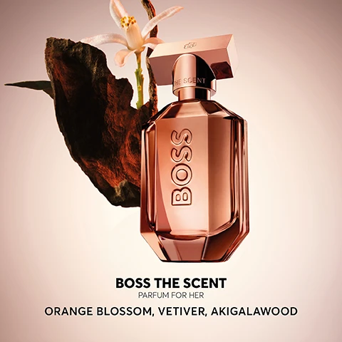 Image 2 - A bottle of Boss The Scent parfum for her, featuring a pinkish glass design, sits beside a dark rock and a white flower, with the text BOSS THE SCENT PARFUM FOR HER ORANGE BLOSSOM, VETIVER, AKIGALAWOOD displayed below.
Image 3 - Image of a perfume bottle labeled BOSS with a sleek, reflective design set against a dark background, featuring a review that states Brilliant bottle design & colour. The scent is so intriguing, but sweet at same time. Love it. and five stars underneath.
Image 4 - The image shows four distinct perfume bottles from the BOSS fragrance line, labeled Eau de Parfum, Magnetic Eau de Parfum, Parfum, and Elixir, with a black background and the heading BOSS THE SCENT above.
Image 5 - A display of two perfume bottles on a circular surface with the name BOSS prominently featured, one bottle is in a light amber color and the other in a dark brown, accompanied by the text THE SCENT PARFUM above them.