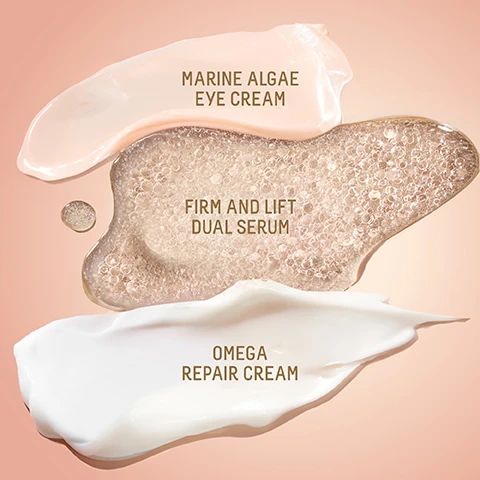 Image 1 - A golden Biossance Squalane + Firm and Lift Dual Serum, a white Squalane + Omega Repair Cream, a peachy Squalane + Marine Algae Eye Cream, and an Uplifting Glow gift set box featuring these products are arranged on a pink surface with a ribbon, alongside text that reads BIOSSANCE::, FULL SIZE FORMAT STANDARD, UPLIFTING GLOW, and a price tag with $65 $112 VALUE. Image 2 - A small brown circle overlay in the top left reads NEW EXCLUSIVE SIZE, while three Biossance skincare products, covered in water droplets and resting on a diagonal gold ribbon against a beige background, are displayed: a small green jar with peach cream labeled BIOSSANCE:: SQUALANE + MARINE ALGAE EYE CREAM Eye Cream Visibly Firms & Instantly Smooths Crème yeux raffermit visiblement et lisse instantanément 5ML; a golden serum in a dropper bottle labeled BIOSSANCE:: SUGARCANE DERIVED SQUALANE SQUALANE + FIRM AND LIFT DUAL SERUM Visibly Tightens • Hyaluronic Acid Resserre visiblement les pores • Acide hyaluronique 15ML; and a large green jar with white cream labeled BIOSSANCE:: SQUALANE + OMEGA REPAIR CREAM Face Cream Deeply Moisturizes Skin Crème visage hydratant la peau en profondeur PLANT DERIVED SQUALANE FULL SIZE 50ML. Image 3 - The image displays three Biossance skincare products with water droplets: an open jar of pink eye cream, an open bottle of golden serum with a dropper, and an open jar of white face cream, alongside the following text: Marine Algae Eye Cream, 97% Showed improvement in the appearance of fine lines and wrinkles after 1 use¹; Firm + Lift Dual Serum, 96% Agree their skin looked lifted in 1 week²; Omega Repair Cream, 100% Showed improvement in skin hydration³; product labels read Biossance™ Squalane + Marine Algae Eye Cream, Eye Cream Visibly Firms & Instantly Lifts, Crème yeux raffermit visiblement & rehausse instantanément, with a Plant Derived Squalane logo; Biossance™ Squalane + Firm and Lift Dual Serum, Visibly Tightens + Hyaluronic Acid, Sérum visiblement raffermissant + acide hyaluronique, with a Plant Derived Squalane logo; Biossance™ Squalane + Omega Repair Cream, Face Cream Deeply Moisturizes Skin, Crème visage hydratant la peau en profondeur, with a Plant Derived Squalane logo; and footnotes state ¹ Based on a clinical study of 33 women, ² Based on participant questionnaires from a clinical study on 26 subjects with twice-daily use, ³ Based on a clinical study of 35 women. Image 4 - A three-step Biossance skincare routine is displayed against a light pink background, titled UPLIFTING GLOW ROUTINE, featuring Step 1: Squalane + Marine Algae Eye Cream which Instantly Lifts Under Eyes, Step 2: Squalane + Firm And Lift Dual Serum which Firms, Lifts, Sculpts The Look Of Skin, and Step 3: Squalane + Omega Repair Cream which is a Lipid-Rich Hydrator Weightlessly Absorbs Into Skin, all described as Fragrance-Free And Suitable For Sensitive Skin. Image 5 - Three swatches of cosmetic products are displayed on a light pink background: a peach cream, a clear bubbly serum, and a white cream, labeled respectively Marine Algae Eye Cream, Firm and Lift Dual Serum, and Omega Repair Cream.