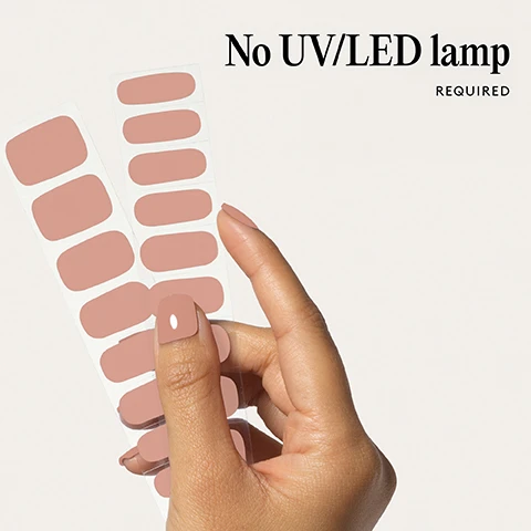 Image 1 - A hand holds two sheets of tan nail stickers, with one sticker applied to a finger, and the text No UV/LED lamp REQUIRED is visible. Image 2 - Two fake fingernails in a light nude color with the text 100% real salon-quality gel. Image 3 - Close up of a persons mouth and hand with manicured nails. Lasts up to 14 days Image 4 - A hand with four fingers extended showing nails painted a nude pink color with the text 1 minute removal NO DAMAGE. Image 5 - Diagram showing four steps for applying nail wraps with icons and text instructions titled Step by step 01 PREP Use a Wooden Cuticle Stick to gently push back your cuticles and buff the shine off your nail plates with a 240 grit nail file Cleanse each nail using a Lint Free Wipe soaked in Prep & Wipe to remove any oils - this helps the wraps adhere better and last longer If you dont have these products, washing your hands is a good alternative If your nails are naturally oily, apply Nail Dehydrator as an extra step after cleansing 02 STICK & WRAP Choose your favourite design and select the right width wrap for each nail - if youre between sizes, go slightly smaller Peel the wrap from the sheet, touching only the end that wont go on the nail Apply the wrap as close to the cuticle as possible without touching the skin Press the wrap firmly from the centre outwards to avoid air bubbles Use your thumb to press down and seal the edges 03 TRIM & FILE Trim any excess as close to your nail length as possible using Curved Edged Scissors After trimming, press the wrap firmly over the free edge of the nail, then file in only one direction, from top to bottom, using a 180 grit nail file Lightly file underneath the free edge to remove excess and align the edges Finish by pressing down again to fully seal the wrap in place Avoid applying any oils or getting your hands wet for at least 2 hours after application to ensure maximum adhesion Then youre set for up to 14 days 04 REMOVE Quick, damage-free removal in just 1 minute Apply Mylee Wrap Remover Oil around the edges of the wrap Gently lift one side with a Wooden Cuticle Stick and slowly slide it underneath, adding more oil as needed Once removed, wipe your nails and wash your hands. Image 6 - A list of bullet points describing nail polish wraps is displayed above three red nail polish wraps on a backing strip. Easiest and gentlest mani in the world Lasts up to 14 days Fast & gentle 1-min removal Fully-cured - No LED Lamp required Comes in 10 sizes Long-lasting shine and chip-resistant Quick and easy application Hema-free, vegan, and cruelty-free Pre-cut and ready to go!