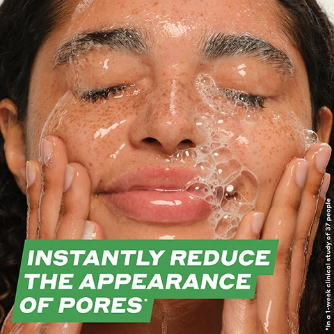 Image 2 - A close-up of a woman with curly hair washing her face, water and bubbles visible on her skin, with text reading INSTANTLY REDUCE THE APPEARANCE OF PORES* in bold white lettering on a green background.
Image 3 - A green tube labeled Daily D-Clog Pore-Clearing Cleanser against a white background, covered in bubbles, with text stating 92% agree it clears blemishes in just 1 week, instantly reduces the appearance of pores, and instantly reduces oil by 78%, along with a note about a clinical study of 37 people after one use.
Image 4 - An image showing a creamy skincare product with a curved dollop, accompanied by labeled icons for key ingredients: Salicylic Acid (BHA), Betaine Salicylate, Danish Purple Willow Ferment, Juniper Berry, and Cucumber Extract, with the text CLEAR PORES + CALM SKIN prominently displayed at the top.
Image 5 - A close-up of light beige, creamy gel with bubbles and a smooth texture, featuring the text PLUSH MILKY GEL WITH A CUSHIONY SOFT LATHER.
Image 6 - A flat lay of skincare products arranged on a light background, including tubes and jars labeled with the following steps: 01 / CLEANSE DAILY D-CLOG CLEANSER Instantly reduces the appearance of pores* 02 / EXTRACT IMPURITIES COLD PLUNGE PORE MASK Clears congested pores* 03 / TREAT BLEMISHES DETOX DROPS TONER Improves blemishes in just 1 week* 04 / HYDRATE STRENGTH MOISTURIZER 2x hydration instantly*