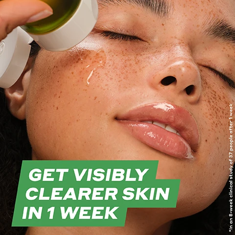 Image 2 - A woman with freckles is applying a skincare product to her face, and the text on the image reads GET VISIBLY CLEARER SKIN IN 1 WEEK followed by a smaller note stating *In an 8-week clinical study of 37 people after 1 week.
Image 3 - A close-up image of a womans chin and mouth area showing a side-by-side comparison of skin before and after treatment; the before image has visible blemishes, while the after image shows clearer skin, accompanied by the text GET VISIBLY CLEARER SKIN IN 1 WEEK* and a note about the clinical study.
Image 4 - Image showing a close-up of a persons nose with a comparison of skin texture before and after treatment; the visible text states 92% AGREE IT UNCLOGS PORES + CLEARS BUILDUP* *In an 8-week clinical study of 37 people.
Image 5 - Image comparing two close-up views of a persons face, labeled BEFORE on the left and AFTER on the right, showing a reduction in shine and improved skin texture; visible text reads INSTANTLY REDUCES SHINE + IMPROVES SURFACE OIL.
Image 6 - A bottle of OLEHENRIKSEN Detox Drops 2% Salicylic Acid Anti-Blemish Toner is displayed with a pink flower and watermelon pieces, alongside text that reads 92% agree it unclogs pores + clears buildup after just 1 week, 97% agree it leaves skin feeling smooth instantly, and improves blemishes in just 1 week.
Image 7 - An assortment of skincare ingredient bubbles including Salicylic Acid, Juniper Berry, Danish Purple Willow Ferment, and Cucumber Extract, with corresponding text describing their benefits for clear blemishes and calm skin.
Image 8 - A collection of amber-colored drops of liquid with small bubbles, featuring text that reads LIGHTWEIGHT DROPS, ABSORB QUICKLY, and RICH AMBER COLOR FROM DANISH PURPLE WILLOW FERMENT.
Image 9 - An image showing five skincare products organized in a visually appealing arrangement, with the top label stating YOUR ACNE ROUTINE followed by the product steps labeled 01 to 04, detailing the products: DAILY D-CLOG CLEANSER, COLD PLUNGE PORE MASK, DETOX DROPS TONER, and STRENGTH MOISTURIZER, along with their benefits.