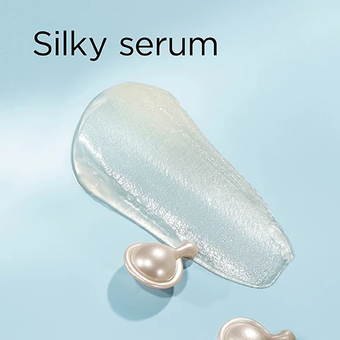 Image 1 - A swipe of clear, shimmering serum gel and two pearl-like capsules are on a light blue background with the text Silky serum. Image 2 - A four-panel image on a light blue background displays abstract visuals: the top left has clear spheres, the top right has water droplets, the bottom left has large clear spheres, and the bottom right features connected small clear spheres, with the text Phytoceramides nourish & strengthen, Size-Shifting HA plumps & fills, and Peptides firm & volumize. Image 3 - A smiling woman with blonde hair and blue eyes looks at the viewer while holding a clear bottle of Elizabeth Arden HYALURONIC ACID + PEPTIDES Ceramide Capsules Hydra-Plumping Serum Sérum Hydratant Repulpant, with text on the image reading 100% show instantly plumper skin* and *Based on a clinical study of 33 panelists immediately after use. Image 4 - A clear bottle of Elizabeth Arden New York Hyaluronic Acid + Peptides Ceramide Capsules Hydra-Plumping Serum, filled with pearlescent capsules, sits on a clear shelf with a silver applicator, against a white tiled background. The visible text states: Why HA + Peptides? Hyaluronic Acid plumps, Peptides firm, the key to plumper, bouncier skin. Image 5 - A split image of a womans face showing a before and after comparison with the before image on the left and after image on the right, displaying visibly plumper and smoother skin in the after image with text that reads BEFORE AFTER Skin looks plumper.