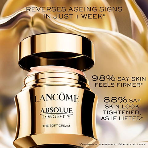 Image 1 - A gold jar of Lancôme Absolue Longevity The Soft Cream with the lid slightly open showing pink cream, alongside text that reads REVERSES AGEING SIGNS IN JUST 1 WEEK*, 98% SAY SKIN FEELS FIRMER*, 88% SAY SKIN LOOK TIGHTENED, AS IF LIFTED*, and *CONSUMER SELF-ASSESSMENT, 50 WOMEN, AT 1 WEEK. Image 2 - A close-up of a golden, fluid-like object with internal lines against a blurry golden background, with the text POWERED BY ABSOLUE PDRN TM KNOWN TO BOOST SKIN ENERGY AND METABOLISM. Image 3 - Close-up profile of a womans face with abstract glowing lines and text Reverse 5 Years of Aging Signs in 1 Month +26% Plumper Inner Contour +36% Firmer Outer Contour. Image 4 - Close-up of a person applying a pink cream to their cheek, highlighting the application area with a dotted circle, with text that reads SILKY, WEIGHTLESS TEXTURE. INTENSELY HYDRATING, FAST ABSORBING. Image 5 - A luxurious gold and black Lancome Absolue The Soft Cream jar is shown with the text THIS JAR IS UNIQUE REFILL IT & KEEP IT PRECIOULY LANCÔME ABSOLUE LONGEVITY THE SOFT CREAM.