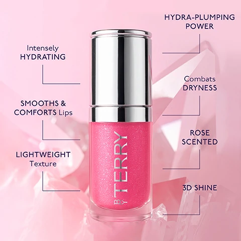 Image 1 - A pink glittery lip gloss bottle with a silver cap stands on a soft pink background with geometric shapes, featuring the text BY TERRY on the bottle, and descriptive text including Intensely HYDRATING, SMOOTHS & COMFORTS Lips, LIGHTWEIGHT Texture, HYDRA-PLUMPING POWER, Combats DRYNESS, ROSE SCENTED, and 3D SHINE. Image 2 - A glossy, shimmery pink liquid or gel is shown with an applicator, alongside text that reads: Key Ingredients BOOSTS & PROTECTS Rosalife Extract BRIGHTENS & RENEWS Vital-Fruit Extract ENHANCES & ILLUMINATES Diamond Glow Complex. Image 3 - The image displays two By Terry lip products on a pink background: a pink Glow Gloss high-performance tinted lip gloss, with its applicator and a shimmering pink swatch, described by text as having Hydra-plumping diamond shine, Sheer to bold, vibrant colour, 8-hour hydration, 94% natural-origin & vegan, Instantly plumps & smooths, and Diamond Glow Complex for 3D pearlescent finish; and a pale pink Lip Oil Serum nutri-sublimating oil-serum hybrid, with its applicator and a shimmering pale pink swatch, described by text as having 3D glass-like shine, Sheer, luminous finish, 24-hour deep hydration, 97% natural-origin & vegan, Instantly plumps, smooths & nourishes, and Starlit Pigments for high light reflection.