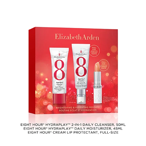 Image 2 - A red Elizabeth Arden gift box adorned with sparkling bokeh lights showcases three products: a white tube of cleanser, a white tube with a pump of moisturizer, and a silver and white lip protectant stick, displaying the text Elizabeth Arden New York, Eight Hour® HydraPlay™ 2-in-1 Daily Cleanser, Nettoyant Quotidien 2 en 1, 1.6 FL. OZ. 50 mL, Elizabeth Arden New York, Eight Hour® HydraPlay™ Skin Perfecting Daily Moisturizer, Hydratant Quotidien Perfecteur de Peau, 1.5 FL. OZ. 45 mL, Full Size, Format Vente (appearing twice), Elizabeth Arden Hydrating Lip Protectant Stick SPF 15, Baume Protecteur Hydratant pour les Lèvres en Bâton FPS 15, DIN 02529777, 3.7 g, Brightening & Hydrating Regimen, and Routine Eclat et Hydratation. Image 4 - A white Elizabeth Arden Eight Hour HydraPlay Skin Perfecting Daily Moisturizer tube is shown next to text that reads Plumps & Hydrates, 97% agree skin feels smoother & looks brighter*, and *Based on a consumer study of 64 participants. The tube itself has text Elizabeth Arden NEW YORK, a large red 8, Eight Hour® HydraPlay™ Skin Perfecting Daily Moisturizer, and Hydratant Quotidien Perfecteur de Peau. Image 5 - A white and red Elizabeth Arden cleanser tube is positioned diagonally next to a light pink product swatch, featuring text Purifies & Refines, 80% saw a reduction in pores*, Elizabeth Arden NEW YORK, a large red number 8, Eight Hour HydraPlay 2-in-1 Daily Cleanser Nettoyant Quotidien 2 en 1, and *Based on a consumer study of 54 participants. Image 6 - An open tube of Elizabeth Arden peachy-orange lip balm with its white patterned cap rests next to glossy swatches of the product on a white surface, with text reading Shields & Softens, 100% agree lips instantly feel smoother*, and *Based on a consumer study of 42 participants. Image 7 - The Elizabeth Arden Eight Hour® Regimen is presented with three products: a 2-in-1 Daily Cleanser for 1 Cleanses & refreshes, a Skin Perfecting Daily Moisturizer for 2 Hydrates & brightens, and a lip balm for 3 Soothes & shields lips.