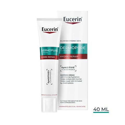 Image 1 - A white Eucerin Dermopure Clinical Hydra Repair product is shown, featuring a tube and a box, with visible text Eucerin, DERMOPURE CLINICAL, HYDRA REPAIR, SymSITIVE Ceramides, DERMATOLOGICAL SKINCARE, BLEMISH-PRONE SKIN, SOOTHING CREAM, 48H intense hydration, Helps restore skin barrier, Helps repair skin irritated by medications, SUITABLE FOR SENSITIVE SKIN, NON-COMEDOGENIC, and 40 ML. Image 10 - The image displays a three-step Eucerin skincare routine with products numbered 1, 2, and 3, set against teal rectangles, and the Eucerin logo at the top right. Product 1 is a green pump bottle labeled Eucerin Dermopure Clinical Purifying Cleanser Salicylic Acid 6% Ampho-Tensides Gentle Removes Excess Oil And Impurities For Blemish-Prone Skin Dermatological Skincare, with the caption Purifying Cleanser and day and night icons below it. Product 2 is a white and teal tube labeled Eucerin Dermopure Clinical Hydra Repair SymSitive Ceramide, with the caption Hydra Repair and day and night icons below it. Product 3 is a white and orange bottle labeled Eucerin 50+ Oil Control Dry Touch Sun Gel-Cream SPF 50+ For Oily And Blemish-Prone Skin, with the caption Oil Control SPF 50+ and a day icon below it. Image 2 - A hand holds a white Eucerin Dermopure Clinical Hydra Repair tube that dispenses a dab of cream onto a finger, with the text Eucerin, DERMOPURE CLINICAL, HYDRA REPAIR, SymSitive + Ceramides, DERMATOLOGICAL SKINCARE, FRAGRANCE FREE, NON-COMEDOGENIC, and SUITABLE ON VERY SENSITIVE SKIN visible on the image. Image 3 - A person with curly hair applies Eucerin cream from a tube to their cheek, with three dots of cream visible, and text in the image reads Eucerin, DERMOPURE, HYDRA REPAIR, SENSITIVE+, L-CARNITINE, Soothing Cream HYDRATES & REPAIRS DURING DRYING ACNE MEDICATIONS. Image 4 - A smiling woman with curly hair holds a tube of Eucerin DermoPure Hydrating Treatment, with text alongside reading Eucerin, 48H INTENSE HYDRATION¹, -87% REDNESS², ¹ Product-in-use, 120 subjects, after 2,4 & 8 weeks, ² Clinical study, 59 subjects, image analysis, 2 weeks of use twice daily, percentage improvement to baseline. Image 5 - The image displays two close-up photos of skin, showing a before and after comparison with the left image labeled Week 0 and the right image labeled Week 2, demonstrating reduced redness and flakiness, accompanied by text that reads Eucerin, Clinically Proven, -87% REDNESS1, and a footnote stating 1 Clinical study, 59 subjects, image analysis, 2 weeks of use twice daily, percentage improvement to baseline. Image 6 - The image shows an old Eucerin Dermopure pump bottle next to a new Eucerin Dermopure Hydra Repair tube, with text that reads NEW LOOK IMPROVED FORMULA, Eucerin, DERMOPURE, CLINICAL, HYDRA REPAIR, SymSITIVE, L-CERAMIDES, DERMATOLOGICAL SKINCARE, OLD, and NEW. Image 7 - A person in a white lab coat holds up a tube of Eucerin skincare product, with visible text reading Eucerin, Recommended by Dermatologists, For oily to blemish-prone skin, Eucerin Dermopure Hydra Repair Sensitiv Ceramide, Dermatological Skincare. Image 8 - Image showing many blue translucent bubbles and the Eucerin logo, with text that reads With soothing SymSITIVE TM Ingredient with neurosensory activity: Regulates the skins hyper-reactivity Provides relief from burning and itching Acts instant and long-lasting. Image 9 - The image shows two side-by-side abstract representations of ingredients, with many blue spheres on the left and several larger clear liquid spheres with smaller droplets on the right, along with the text SymSITIVE™ To regulate the sensitivity of the skins hyper-reactivity Ceramides To strengthen the skins barrier function for reduced moisture loss Eucerin.