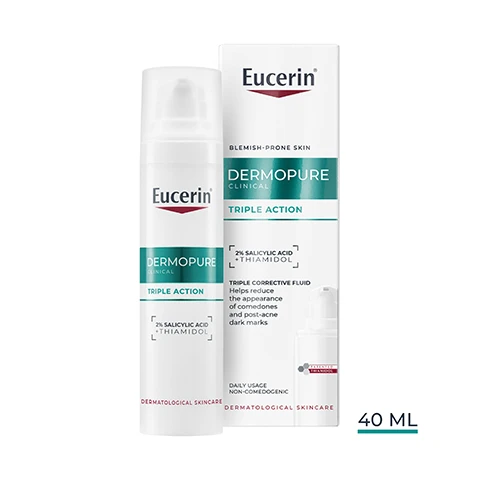 Image 1 - A white Eucerin Dermopure Clinical Triple Action pump bottle stands beside its matching retail box, both featuring prominent product details and visible text including Eucerin, DERMOPURE CLINICAL, TRIPLE ACTION, 2% SALICYLIC ACID + THIAMIDOL, DERMATOLOGICAL SKINCARE, BLEMISH-PRONE SKIN, TRIPLE CORRECTIVE FLUID Helps reduce the appearance of comedones and post-acne dark marks, DAILY USAGE, NON-COMEDOGENIC, and 40 ML. Image 10 - The image displays a three-step Eucerin skincare routine: Product 1 is a green pump bottle labeled Eucerin BLEMISH-PRONE SKIN CLINICAL DERMOPURE PURIFYING CLEANSER SALICYLIC ACID WITH RESPECT GENTLE Clears excess oil and impurities Unclogs pores For sensitive blemish-prone skin DERMATOLOGICAL SKINCARE and is captioned Purifying Cleanser; Product 2 is a white pump bottle labeled Eucerin DERMOPURE TRIPLE ACTION 10% SALICYLIC ACID DERMATOLOGICAL SKINCARE and is captioned Triple Action; Product 3 is a white and orange bottle labeled Eucerin SUN PROTECTION 50+ OIL CONTROL DRY TOUCH SUN GEL-CREAM ULTRA LIGHT and is captioned Oil Control SPF 50+; with the Eucerin logo visible at the top right. Image 2 - A hand holds a white Eucerin DermoPure Triple Action bottle with a drop of liquid dispensing from the pump, with visible text reading Eucerin, DERMOPURE, TRIPLE ACTION, 2% SALICYLIC ACID, L-THIAMIDOL, NON-COMEDOGENIC, FAST ABSORPTION, OIL-FREE. Image 3 - Two white Eucerin Dermopure bottles, one upright and one lying down, are displayed on a teal background with text showing product benefits and study details: Eucerin, Eucerin DERMOPURE TRIPLE ACTION 10% SALICYLIC ACID THIAMIDOL, -66% PIMPLES¹, -80% MARKS², -62% COMEDONES¹, ¹ Real-world-evidence study, skin care regimen: Cleansing Gel, Triple Effect Serum and SPF 30 Day Care, lesion count, 12 weeks of use twice daily, compared to baseline. ² Clinical study, self-grading score, 43 volunteers, 12 weeks of use twice daily, compared to baseline. Image 4 - A man with blonde curly hair and a woman with braided hair are looking at the viewer, with text on the right side reading Eucerin, Triple Action PIMPLES MARKS COMEDONES, RESULTS FROM DAY 1. Image 5 - A before and after image shows skin with severe acne, including a large whitehead, on the left labeled Week 0, and significantly clearer skin on the right labeled Week 12, with visible text Eucerin Clinically Proven -66% PIMPLES¹ and a footnote stating Real-world-evidence study, skin care regimen containing a cleansing gel, Triple Effect Serum and an SPF 30 day care, lesion count, n=427, 12 weeks of use twice daily, compared to baseline. Image 6 - The image displays an old blurred Eucerin Dermopure bottle next to a new clear Eucerin Dermopure Clinical Triple Action bottle, with visible text reading Eucerin, New Look Same Formula, 2% Salicylic Acid + Thiamidol, Dermatological Skincare, Old, New. Image 7 - A person in a white lab coat holds a white Eucerin DermoPure bottle, with text reading Eucerin, RECOMMENDED BY DERMATOLOGISTS, FOR OILY TO BLEMISH-PRONE SKIN, and on the bottle Eucerin, DERMOPURE, TRIPLE ACTION, 2% SALICYLIC ACID THIAMIDOL, DERMATOLOGICAL SKINCARE. Image 8 - An abstract image shows a foreground sphere with a honeycomb pattern and splashing liquid, and a blurred sphere behind it, with the Eucerin logo in the top right, and text below that reads: With patented Thiamidol®, Most effective anti-mark ingredient, Reduces melanin production from day 1¹, Effective on all skin types & tones, including a hexagonal logo with PATENDED THIAMIDOL, and a small footnote ¹ Expert Statement by Dr. Ludger Kolbe STDR-075431C (inhibition, in vitro). Image 9 - The image displays a teal green viscous substance on the left and several translucent pinkish spheres, one large, on the right, with the text Eucerin 2% Salicylic Acid To exfoliate and unclog blocked pores Patented Thiamidol® Clinically proven to reduce post-acne marks.