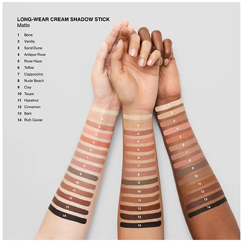 Image 1 - Three arms with light, medium, and dark skin tones are shown with 14 swatches of cream shadow stick shades, accompanied by a list of the shade names: LONG-WEAR CREAM SHADOW STICK Matte 1 Bone, 2 Vanilla, 3 Sand Dune, 4 Antique Rose, 5 Rose Haze, 6 Toffee, 7 Cappuccino, 8 Nude Beach, 9 Clay, 10 Taupe, 11 Hazelnut, 12 Cinnamon, 13 Bark, 14 Rich Caviar. Image 2 - A quad collage shows three different skin tones with dark winged eyeliner, alongside a close-up of a black eyeliner pencil with a smudger tip and the text RICH CAVIAR. Image 3 - A fan of Bobbi Brown long-wear cream shadow sticks in various shades is displayed with the text 24HR WEAR, WONT SMUDGE OR CREASE, WEAR-ANYWHERE SHADES, and the brand name Bobbi Brown along with the shade Golden Pink visible on the products. Image 4 - The image displays a side-by-side comparison of Bobbi Brown makeup stick packaging: on the left, two black Bobbi Brown sticks, one open with a nude tip and one closed with a black cap, are shown above the text PREVIOUS PACKAGING; on the right, two black Bobbi Brown sticks, one open with a nude tip and one closed with a nude cap, are shown above the text New look SAME FORMULA. Image 5 - A model applies a shimmery reddish-purple eyeshadow to her eyelid, next to two rectangular color swatches labeled Antique Rose (Matte) and Mulberry (Shimmer). Image 6 - A close-up of a person applying a brown eyeshadow stick to their upper eyelid, with two brown color swatches displayed vertically on the left labeled CINNAMON (MATTE) and DOWNTOWN BROWN (SHIMMER). Image 7 - Three Bobbi Brown Long-Wear Cream Shadow Sticks in matte brown, multi-chrome champagne, and shimmer plum are displayed with swatches behind each, alongside text that reads LONG-WEAR CREAM SHADOW STICK 3 Finishes, BOBBI BROWN (on each stick), MATTE True matte, MULTI-CHROME Multidimensional sparkle, and SHIMMER Soft sparkle.