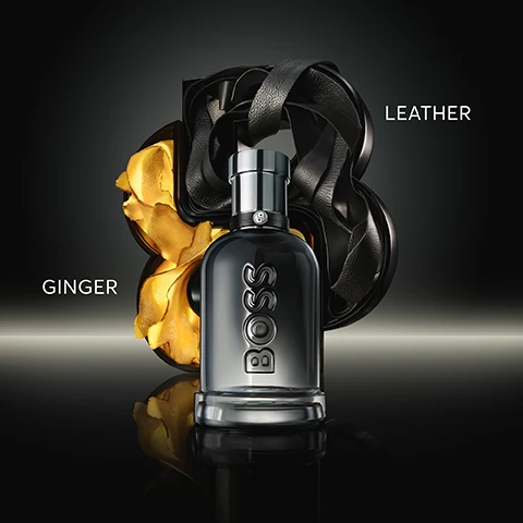 Image 2 - A metallic grey BOSS perfume bottle is positioned centrally against a dark background, flanked by abstract golden ginger on the left and black leather-like ribbons on the right, with the words GINGER and LEATHER visible next to their respective elements. Image 3 - Three men, Vinicius Jr., Bradley Cooper, and Maluma, pose with a dark grey BOSS perfume bottle, against a dark background, with the visible text BOSS, BOTTLED BEYOND, THE NEW GINGER-LEATHER FRAGRANCE. Image 4 - A dark grey BOSS perfume bottle stands in front of a sculptural object with gold and black elements on a dark background, with text reading BOSS, My new go-to fragrance, its become one of my favourites. The scent is really clean with just the right hint of spice. Ansar, Home Tester Club, and a five-star rating. Image 6 - Three dark glass BOSS perfume bottles with metallic caps are displayed in increasing sizes, labeled 50ML, 100ML, and 150ML. Image 7 - Five Boss Bottled fragrance bottles are arranged on a reflective dark surface with corresponding product names, characteristic descriptions, and circular intensity indicators above each, displaying the text: BOSS BOTTLED Eau de Toilette Fresh & Masculine Parfum Warm & Sophisticated Elixir Rich & Charismatic Absolu Powerful & Alluring Beyond Vibrant & Sensual.