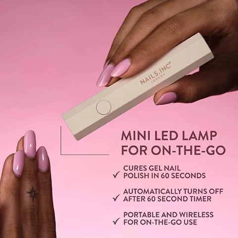 Image 1 - A persons hand with pink manicured nails holds a rectangular cream-colored Nails.inc London mini LED lamp, while another hand with matching pink nails and a small star tattoo is visible in the foreground against a pink background, with text reading MINI LED LAMP FOR ON-THE-GO, CURES GEL NAIL POLISH IN 60 SECONDS, AUTOMATICALLY TURNS OFF AFTER 60 SECOND TIMER, PORTABLE AND WIRELESS FOR ON-THE-GO USE. Image 2 - A hand holds a beige Nails.Inc London LED lamp over another hand with pink nails. The visible text reads: Speedy Curing Time, Cures in 60s, LED Lamp Curing Is Required, and *Disclaimer: Cure time is dependent on a number of variables based on thickness of coats, number of coats, and LED Lamp used. Image 3 - A beige hexagonal Nails.INC London device is shown being charged by a white USB cable, with text reading LONG LASTING FOR TRAVEL, Lamp Power: 3W, Charging Time: 2 Hours, and Using 3W the LED can be used for 20,000 hours.