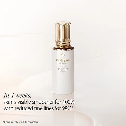Image 2 - A white and gold bottle of Clé de Peau Beauté Protective Day Emulsion stands on a light surface with a creamy reflection; text reads In 4 weeks, skin is visibly smoother for 100% with reduced fine lines for 98%* and *Consumer test on 107 women. Image 3 - A promotional image features clear glass tubes with liquid and bubbles winding around a light background and white flower petals, with two circular insets: one of vibrant green leaves labeled Hydrangea Serrata Leaf Extract to support the skins 24-hour circadian rhythm*, and another of white lily flowers labeled Radiant Lily Extract to act on skin defense, with *In-vitro test in the bottom right. Image 4 - A white bottle and a dark blue bottle of skincare emulsion, both with gold caps, are displayed in front of white flowers and clear tubes with liquid droplets, with visible text that reads PLUMP, with the Day/Night Emulsions, Clé de Peau BEAUTÉ ÉMULSION JOUR PROTECTRICE PROTECTIVE DAY EMULSION, and Clé de Peau BEAUTÉ ÉMULSION NUIT INTENSIVE INTENSIVE NIGHT EMULSION.